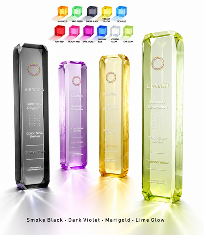 Four faceted rectangular acrylic award plaques in Smoke Black, Dark Violet, Marigold, and Lime Glow, displayed on a white background with a color options chart at the top and product names at the bottom.