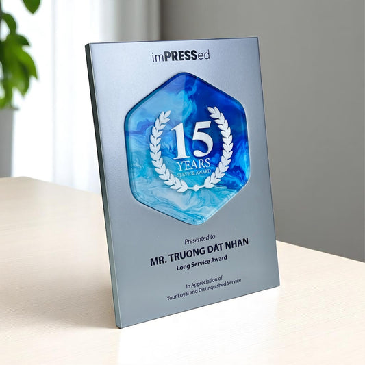 Award Singapore Recognition Plaque with '15 Years' service award on a metal finished surface, made of acrylic